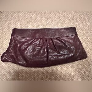 Lauren Merkin pleated lambskin clutch bag. Hinge top frame. 5"H x 11"W x 1"D.